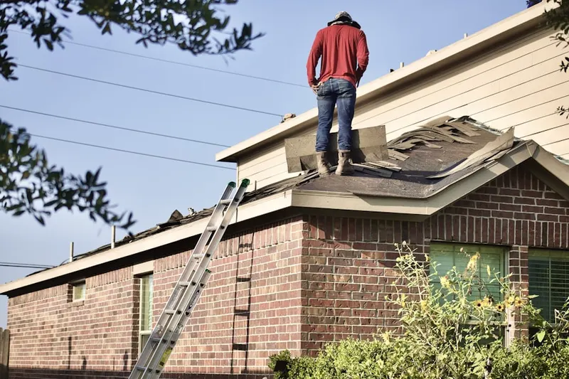 Professional roofer working on a residential roof in La Joya